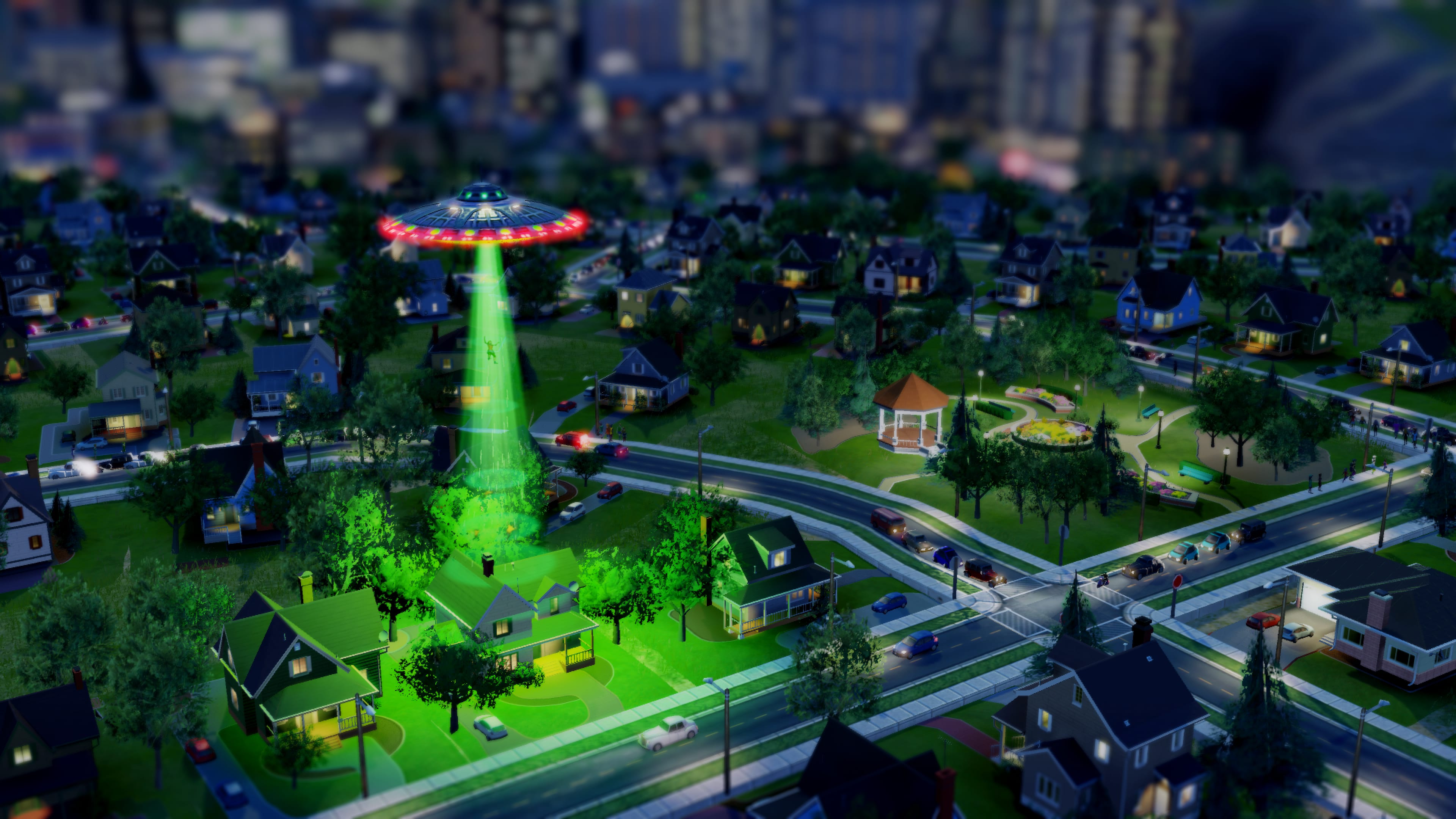 A UFO abducts a figure with a green beam over a SimCity neighborhood at night.