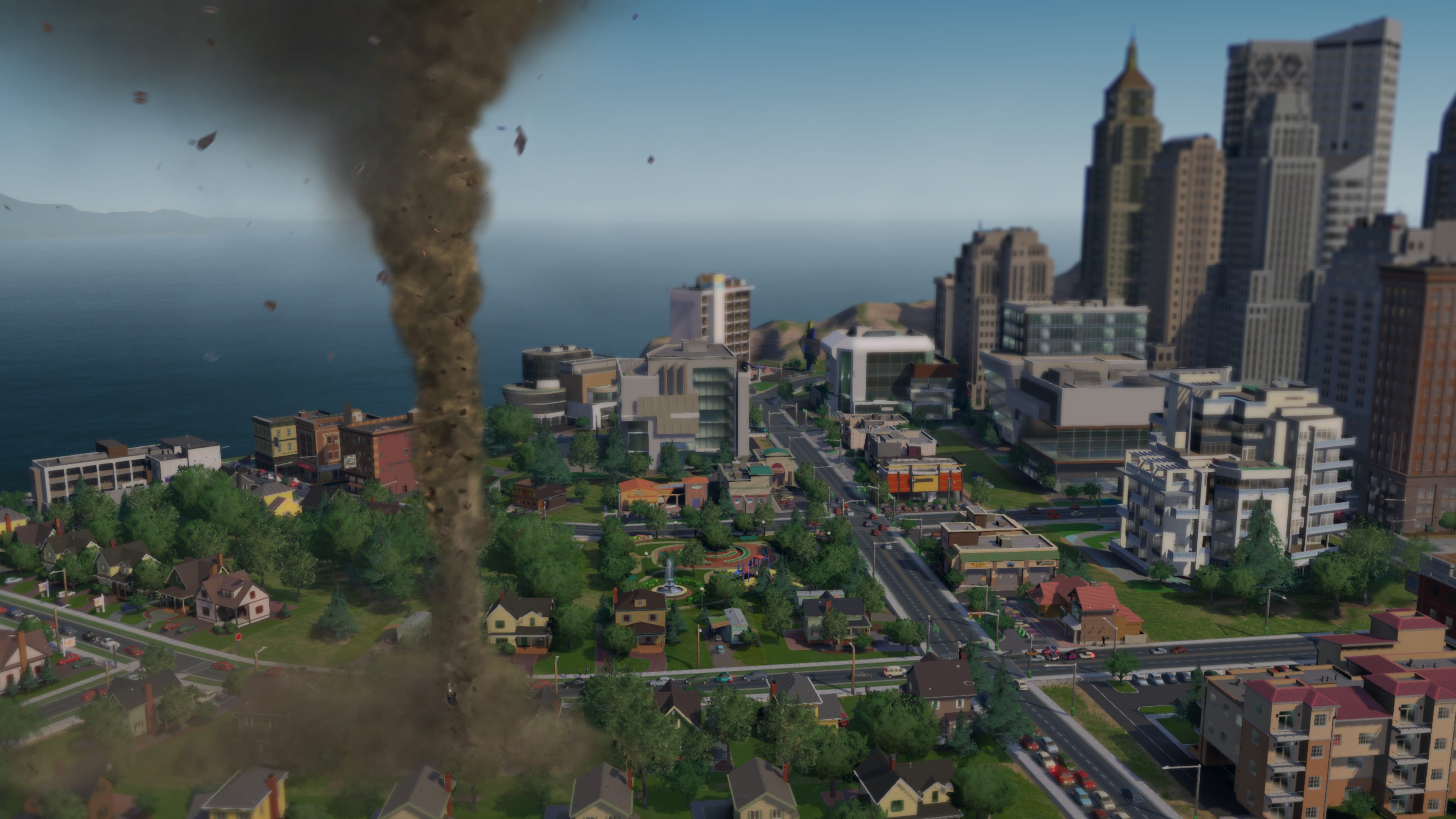 A tornado touches down in a SimCity city near high-rise buildings.